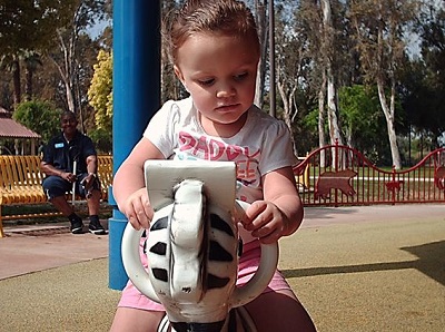  a child on a rocking horse at the sensory playground